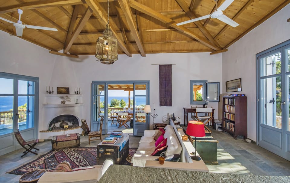 Living room from the kitchen: French windows opening to the South, East and West