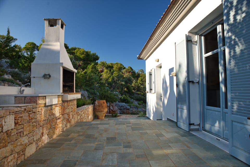 West terrace, BBQ, marble sink and surface for food preparation. Front door on r