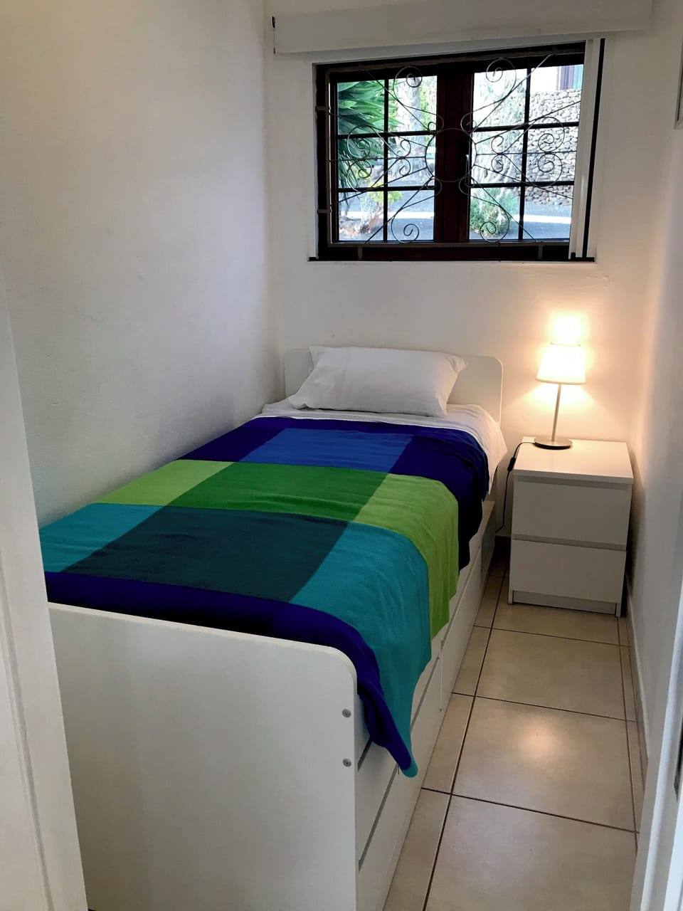 Third bedroom, under-bed storage. Mosquito nets. Fan.
