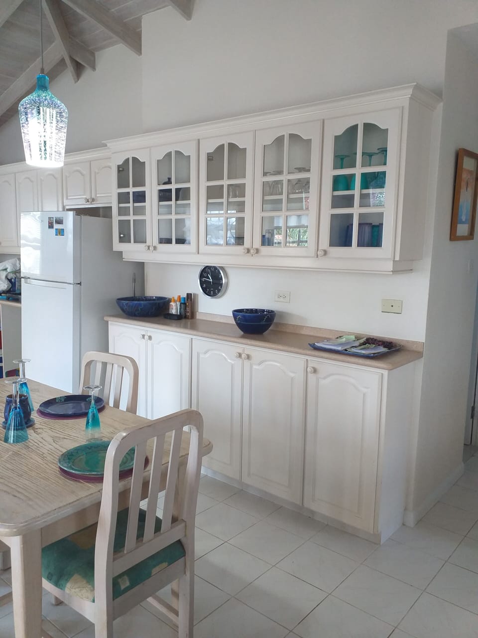 Eating area and crockery unit. Dimmer lighting above table for eating in evening