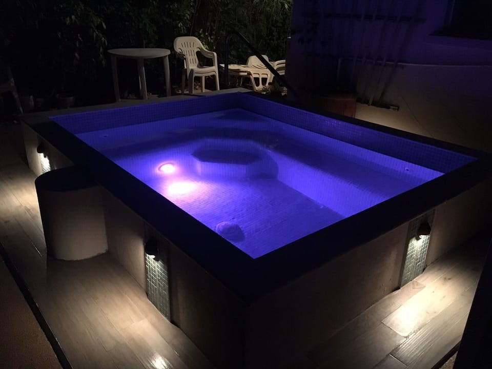 Newly refurbished pool by night with lighting effects.
