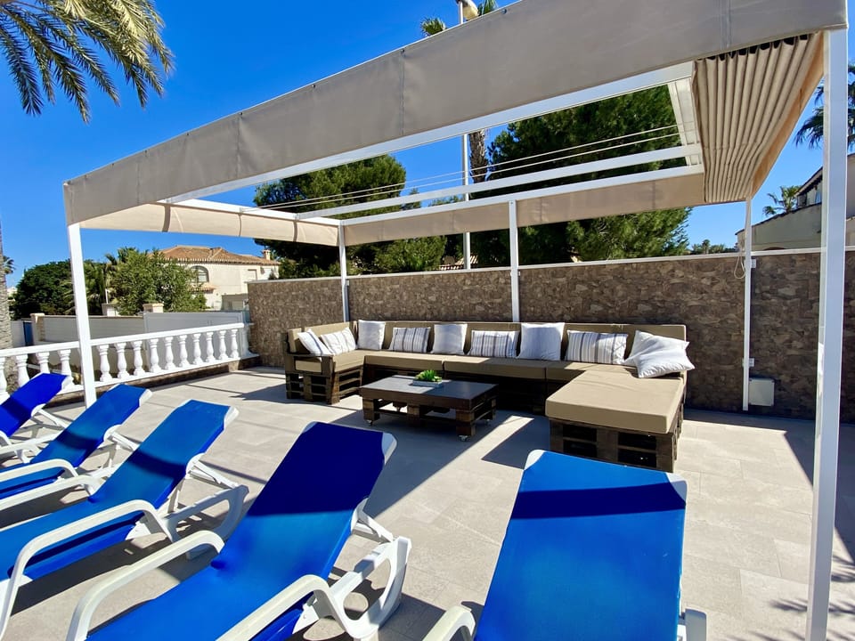 Poolside gazebo with Shade Awning and sofa seating 