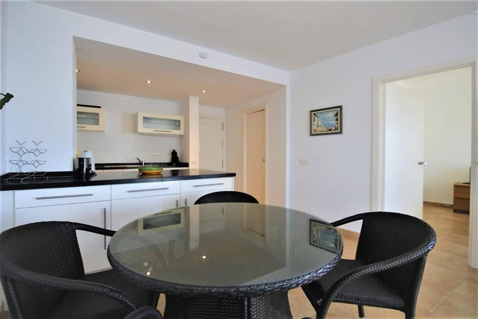 Dining area next to the open kitchen with seating for four guests