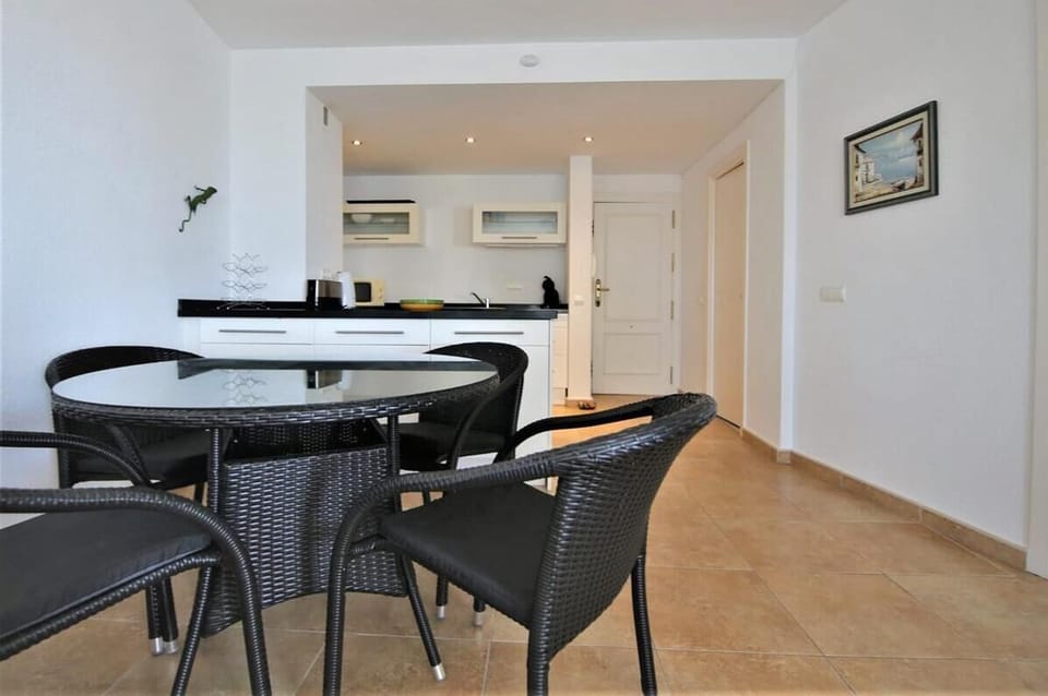 View of the open kitchen and dining area for four from the lounge
