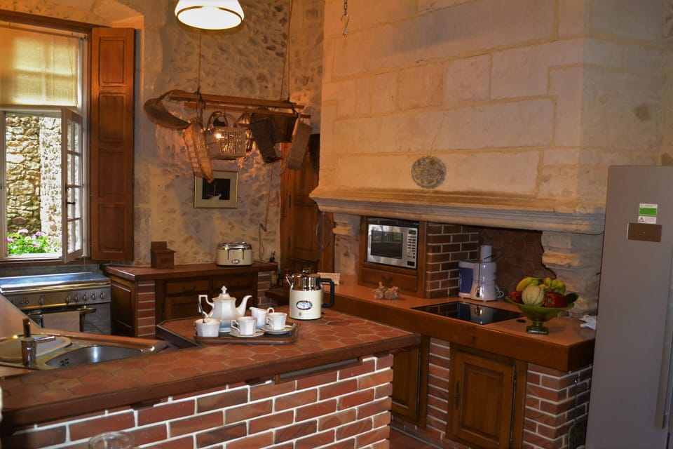 Kitchen with American fridge freezer,  electric hob, gas range