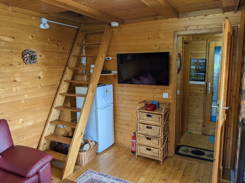 Lounge TV with stairs up to family bedroom