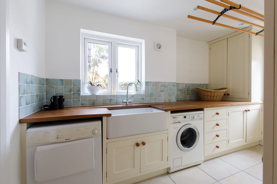Utility room with Miele washing machine, tumble drier and Belfast sink