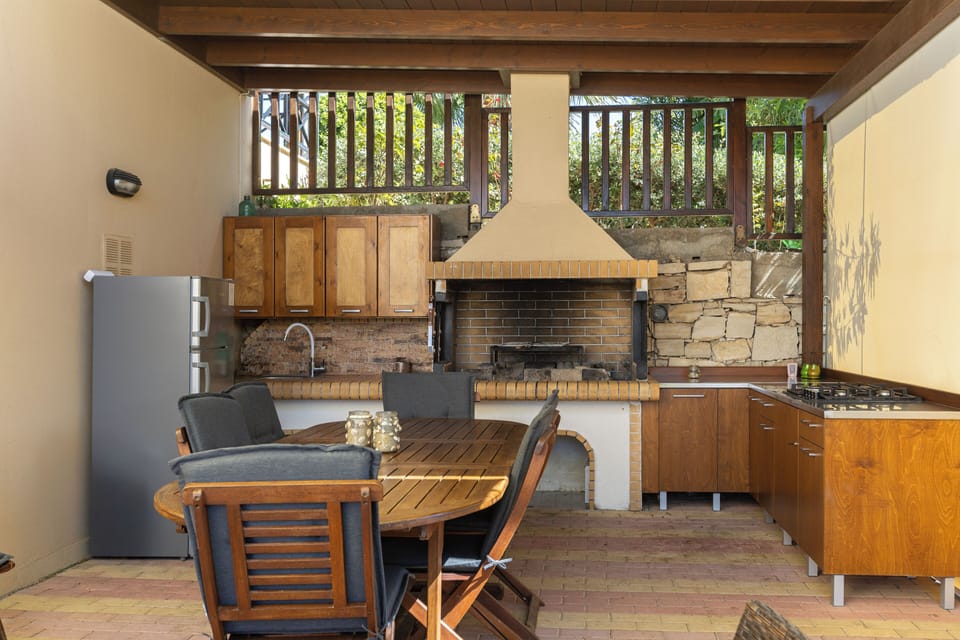 Fully equipped barbecue facilities, including a charcoal grill and sink.