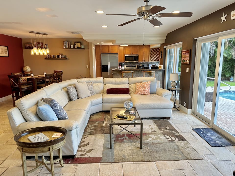 Living area with genuine leather sectional, kitchen and dining area 