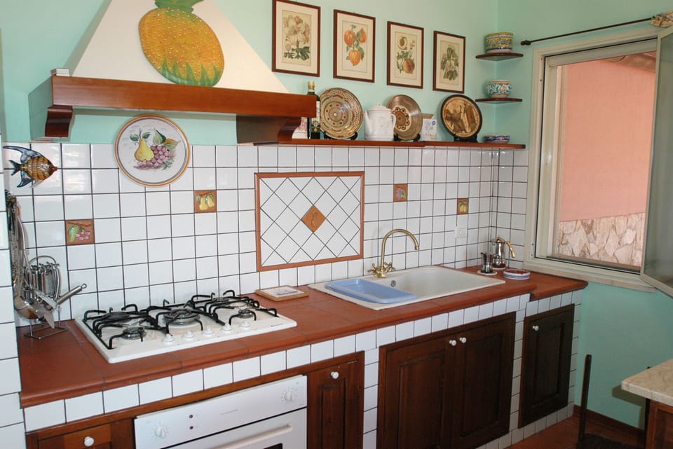 Kitchen with 5 gas cookers, electric oven, dishwasher, microwave and toaster.