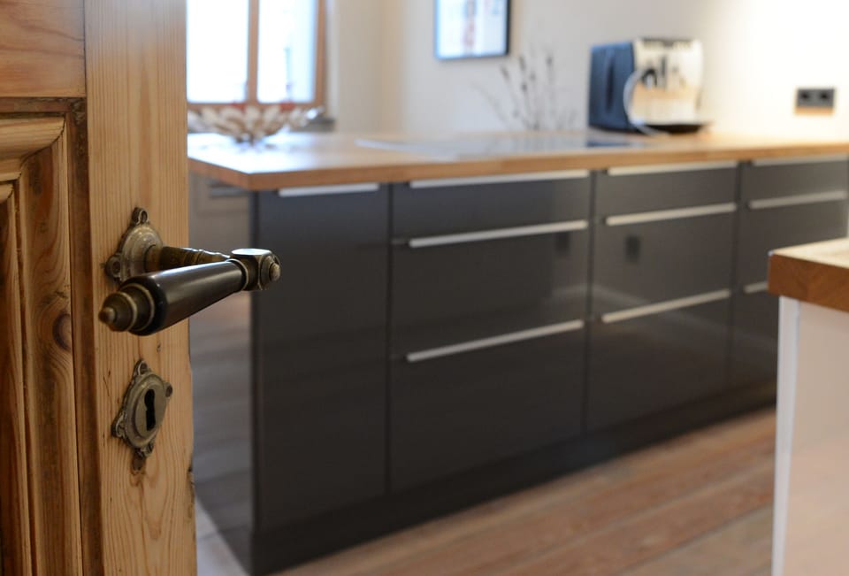 Modern kitchen in the lavishly renovated, stucco room ...