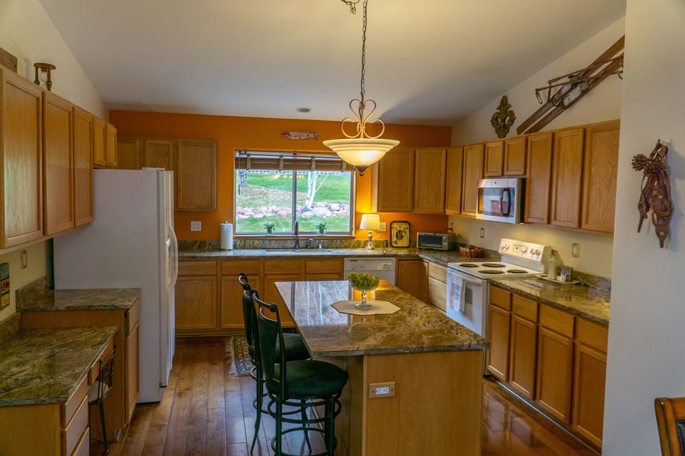 Kitchen area includes a gathering island & walk-in pantry. 