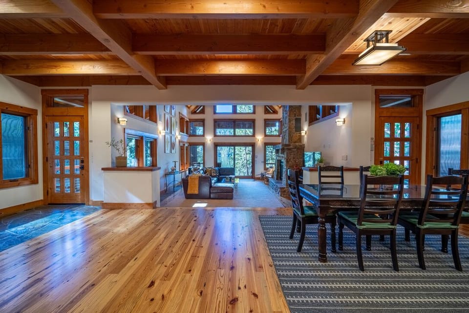 Lower level with uncluttered, open space, dining table, kitchen and side office