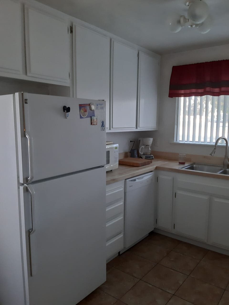 Kitchen has spacious refrigerator and plenty of cupboard space.