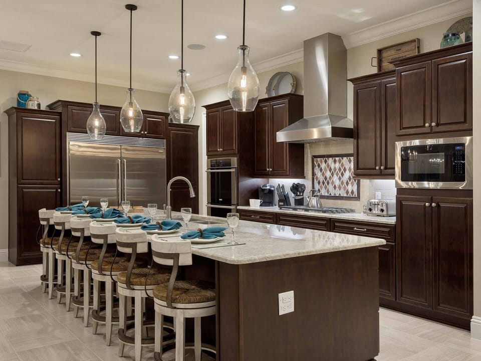The gourmet kitchen is equipped with high-end appliances and marble countertops