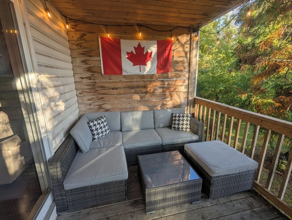 Seating lounge on back deck facing ravine and river