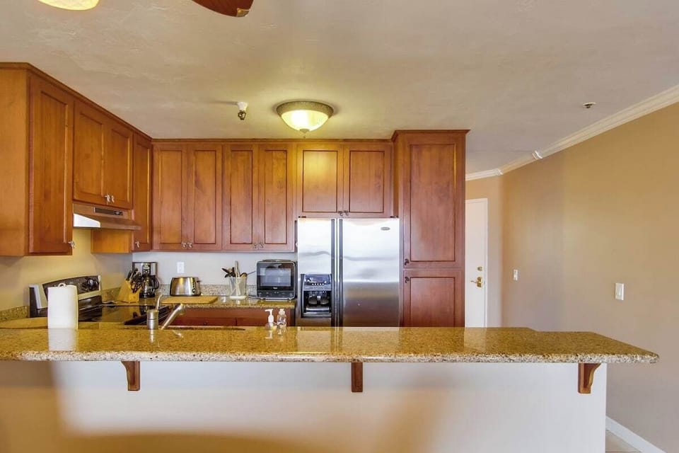 Kitchen with an oven, blender, refrigerator, recessed lighting, microwave, sink, toaster, coffee, stainless steel appliances
