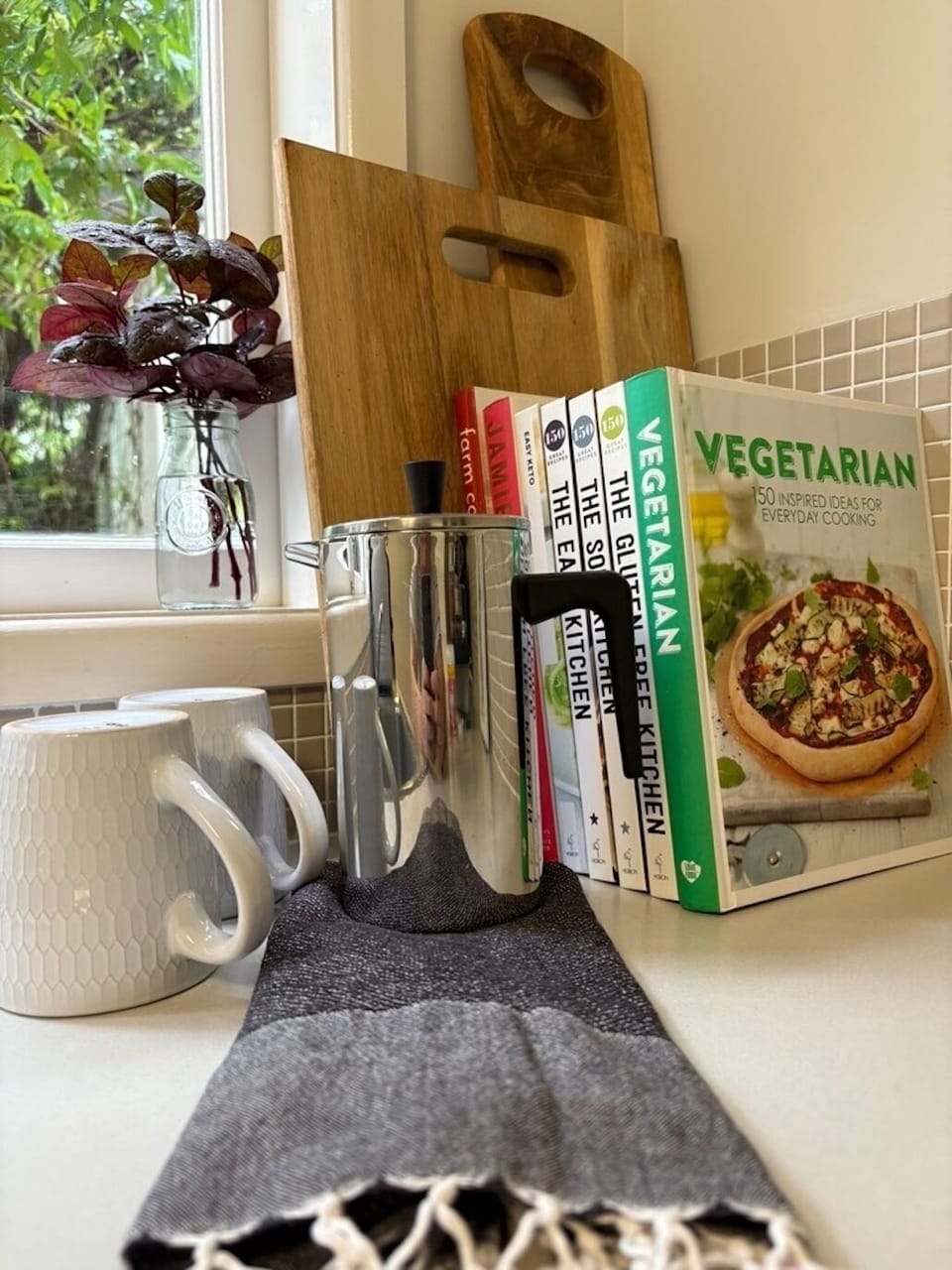 Kitchen/laundry with some recipe books to enjoy during your stay.