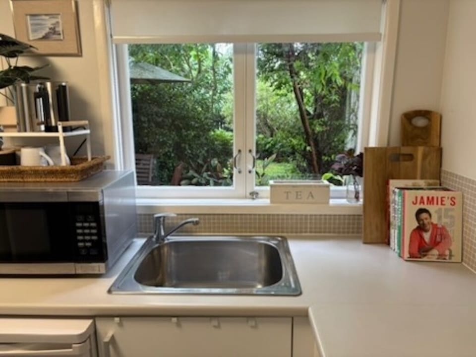 Kitchen/laundry with view to garden and your private courtyard.
