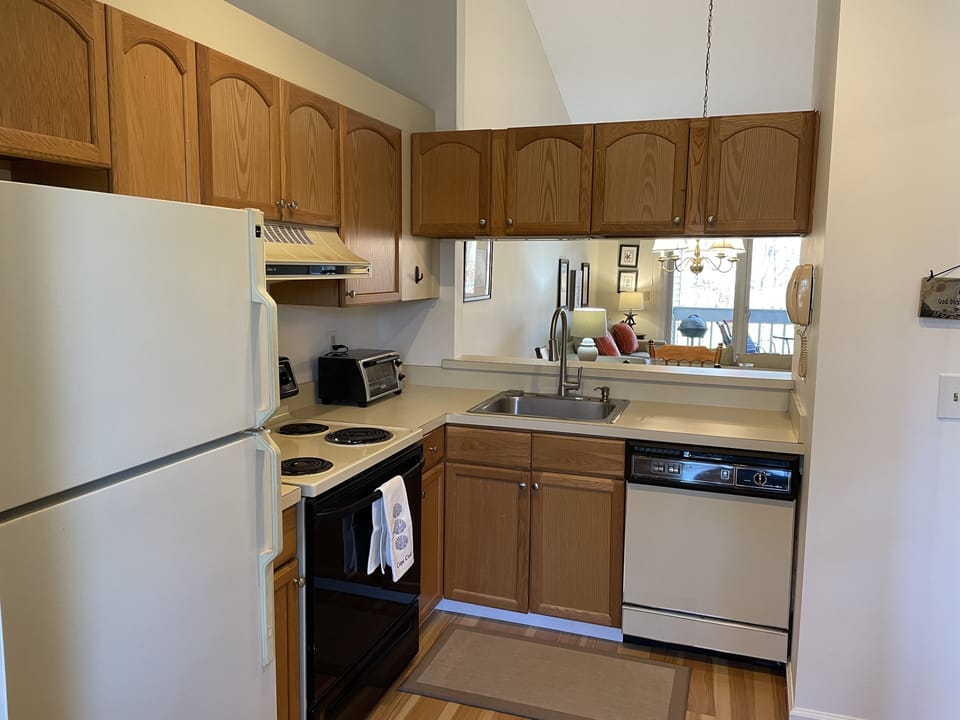 Wood floor continues in the fully stocked kitchen.