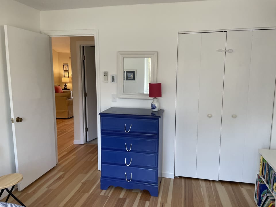 Twin bedroom also has mini split ac, ceiling fan, and window shades.