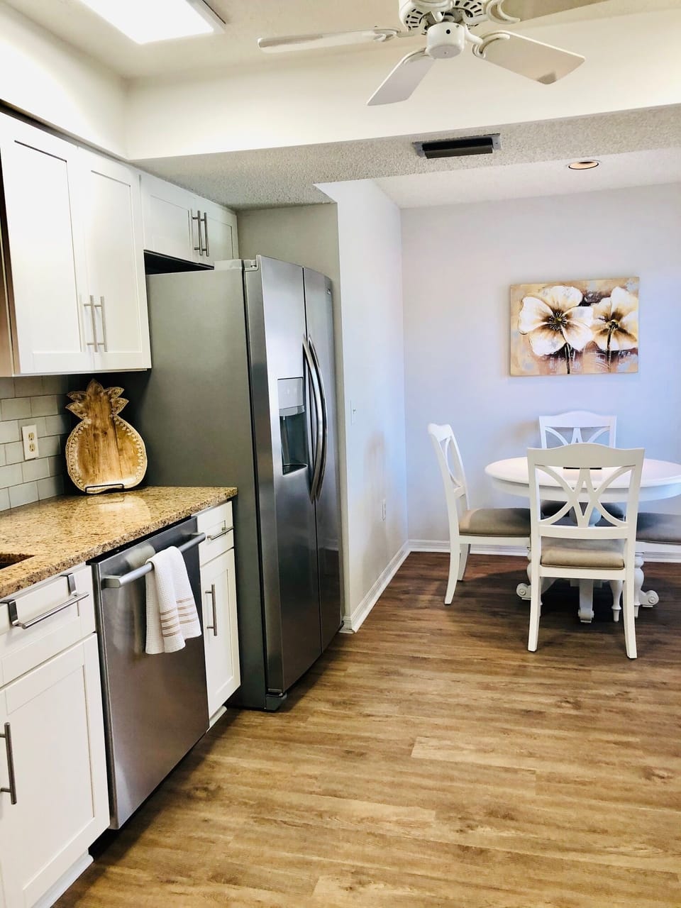 The bright eat-in-kitchen boasts new stainless steel appliances.