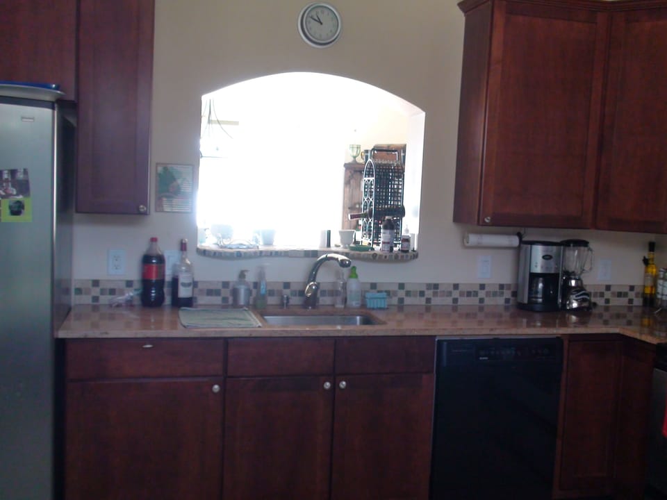 Kitchen sink with lake view through dining room