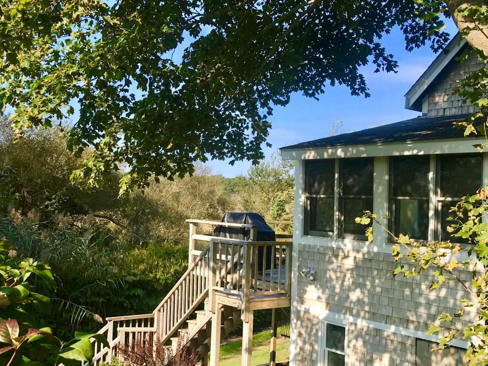 Walk to town center or the harbor from this marshland cottage