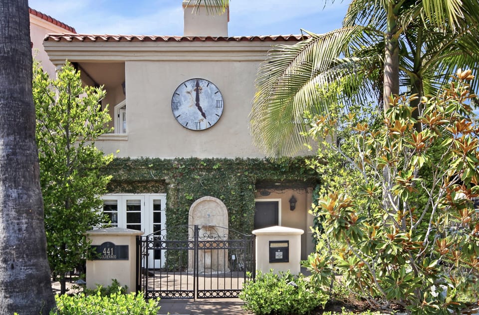 The old world charm and tropical landscape of this corner home