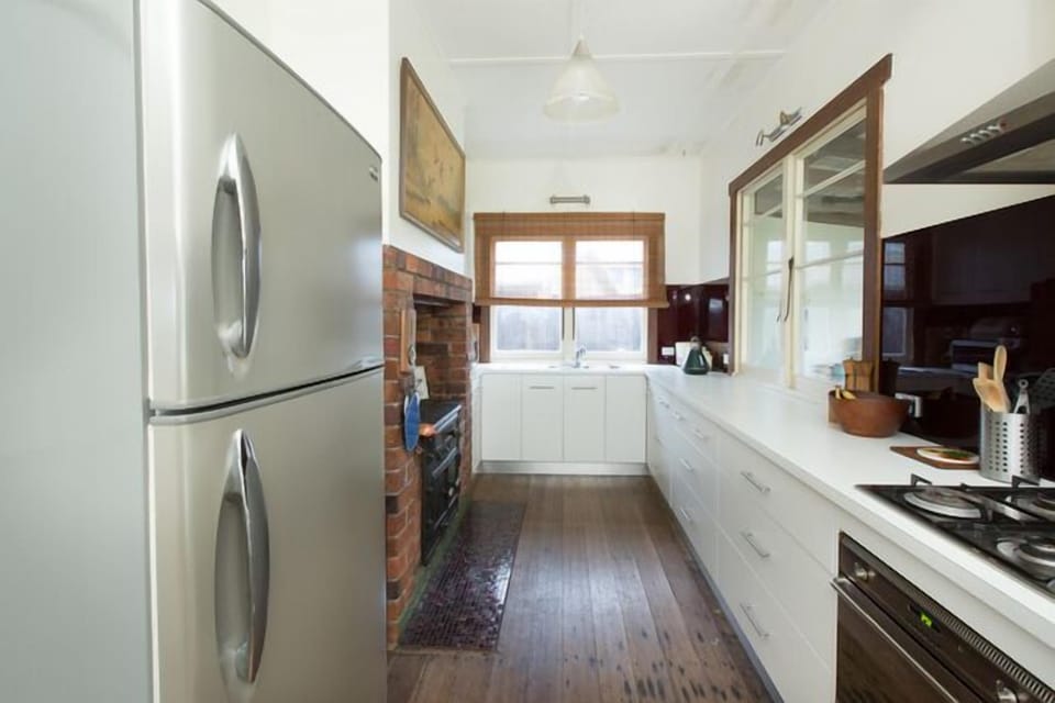 Expansive galley kitchen with all modern conveniences & wood stove.