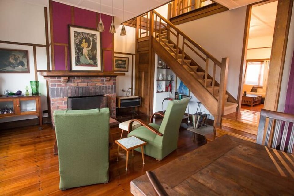 Comfortable chairs by the open fire in the formal dining room