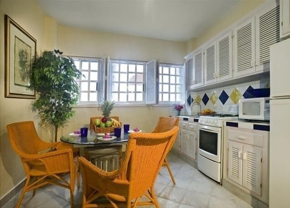 Kitchen in suite five. Dining table has been replaced with a chair & tv.