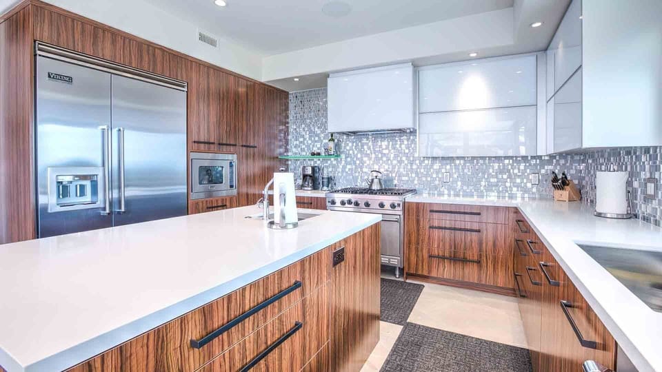Gorgeous kitchen w/ large fridge, gas stove, two sinks, island, & backyard views