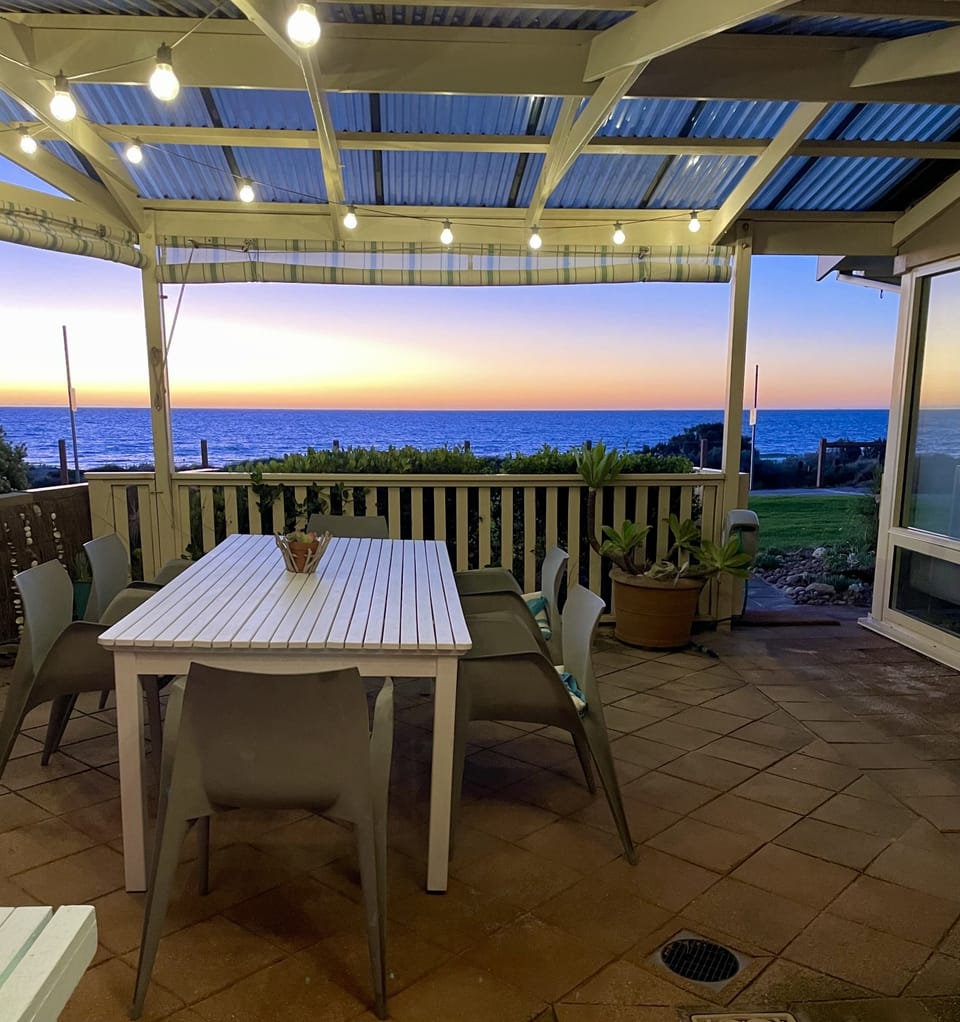 Outdoor covered patio with festoon lighting, BBQ (webber Q) and seating for 8+