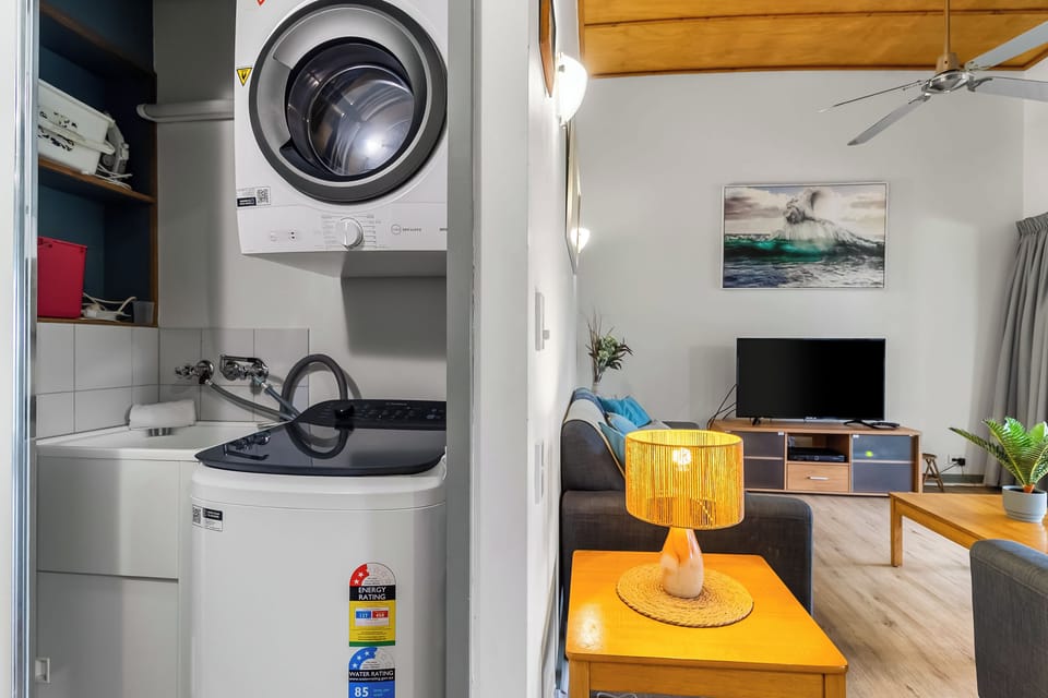 Modern laundry in hallway cupboard.