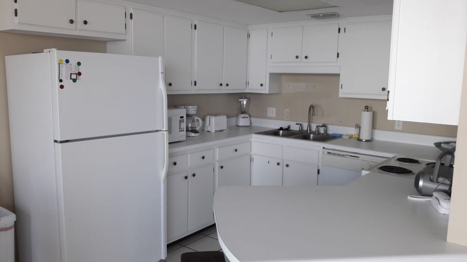 Classy white kitchen with Ocean views fully equipped to prepare a gourmet meal!