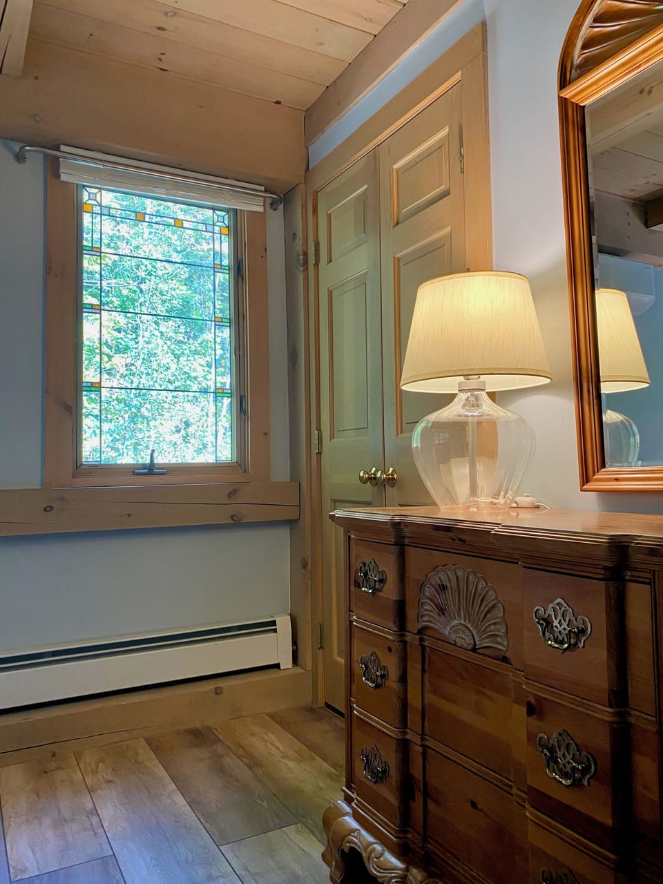 Cozy first floor bedroom with dresser and closet
