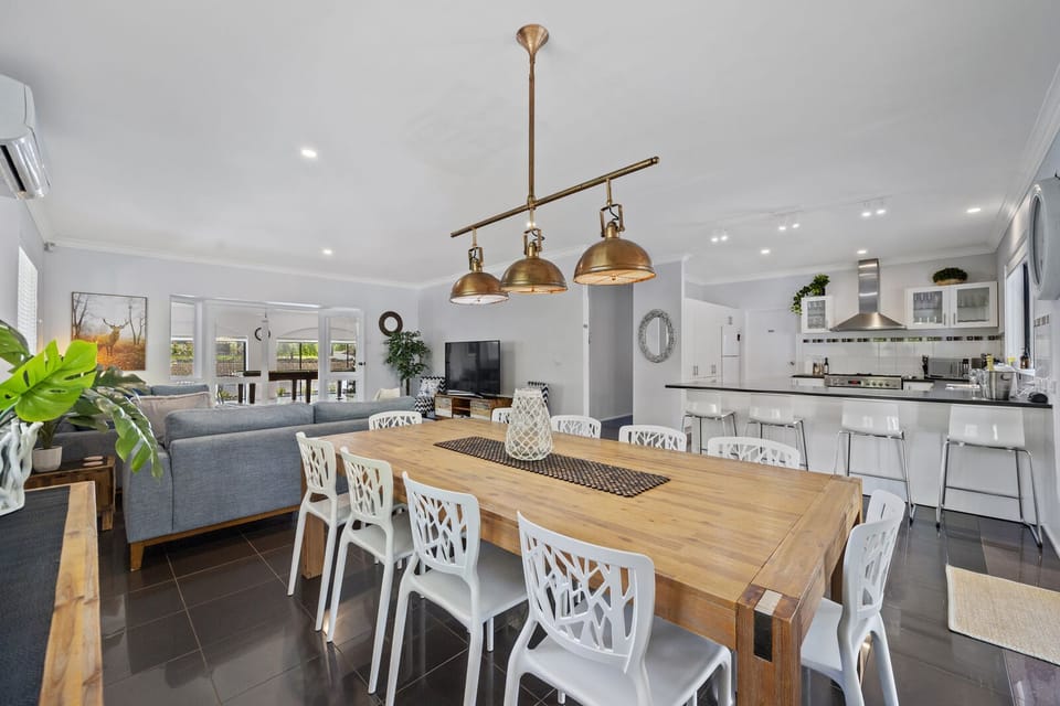Dinning room with adjoining breakfast bar and exit to undercover alfresco area