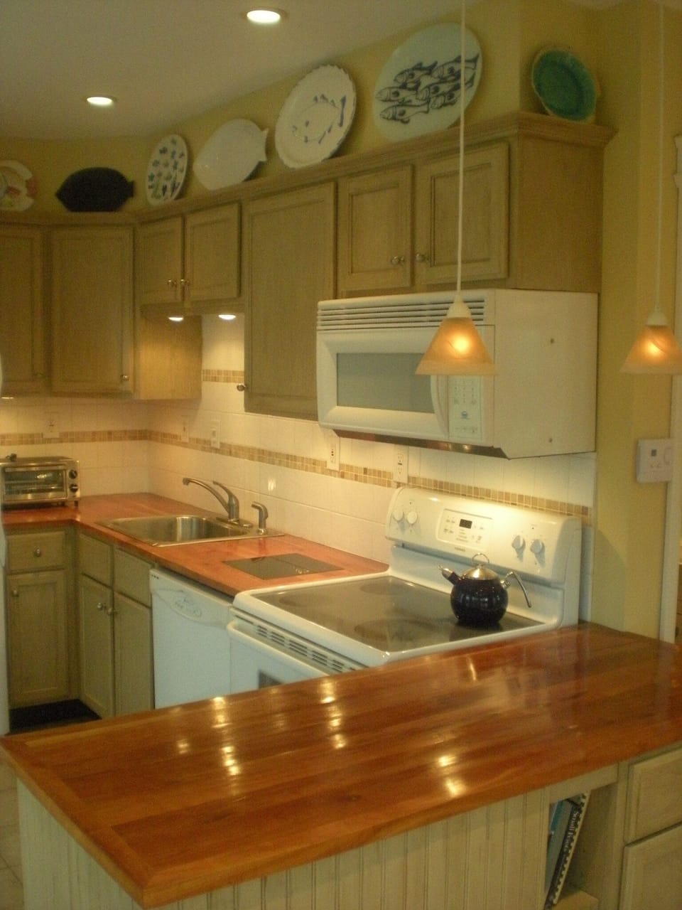 Fully stocked kitchen with dishwasher, microwave, stove, oven, pots/pans, dishes