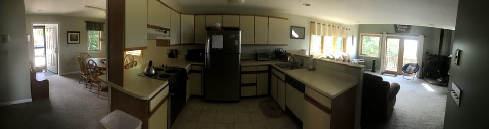 Wide angle of the 1st floor dining room, kitchen and living room.