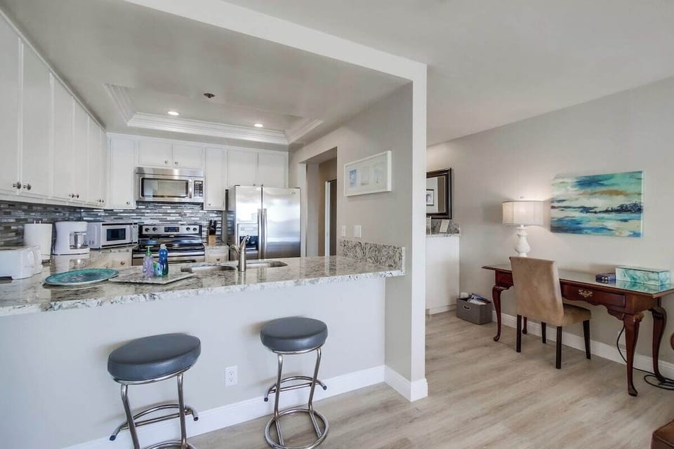 Open kitchen to keep engaged with breakfast bar seating for 2. Desk space to work from home!