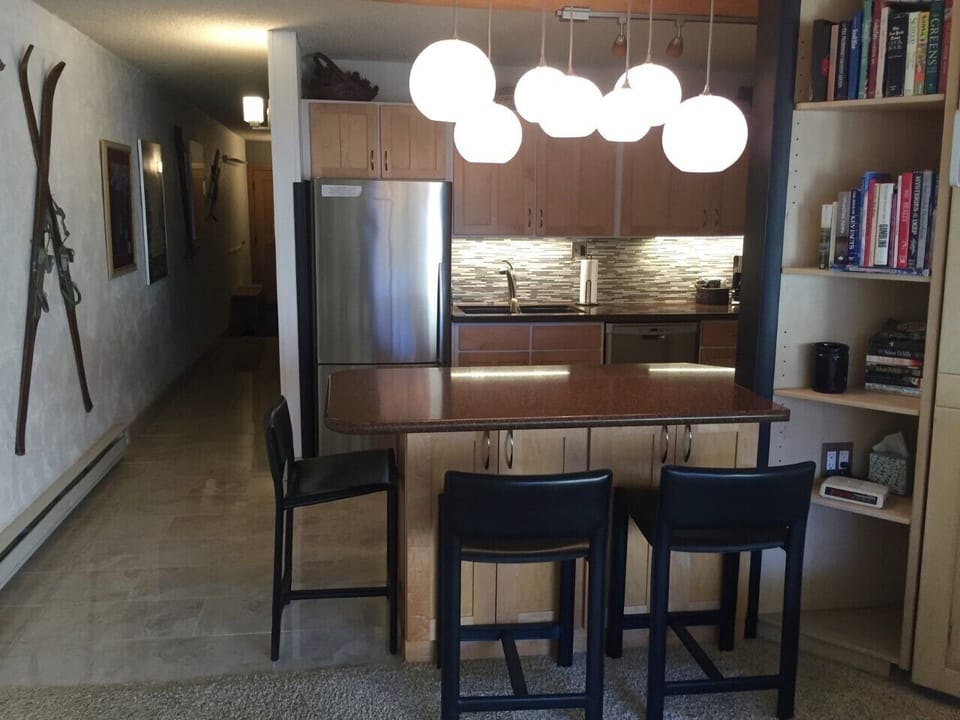 Island seating for 5 from living room with kitchen in background