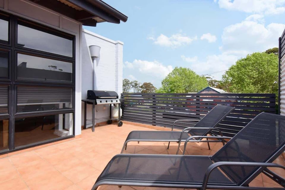 Sun lounges and BBQ area in 'Plantation', one of Nautilus Jervis Bay holiday apartments.