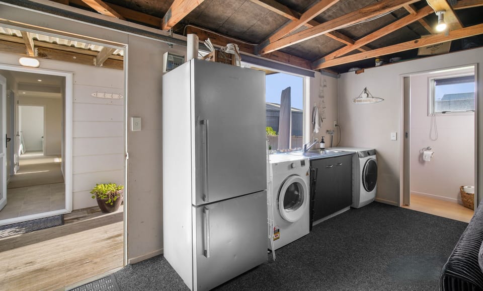 Garage with laundry and additional toilet.