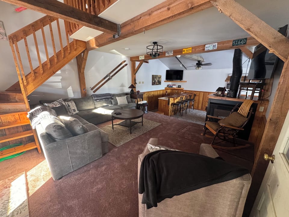 This cozy but bright living room has a gas fireplace and TV