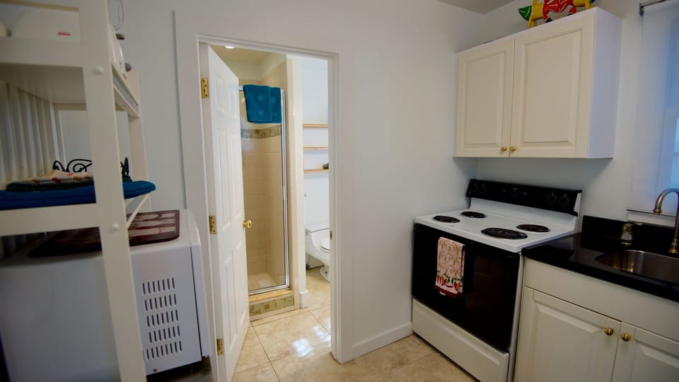 The bathroom is located off of the kitchen.