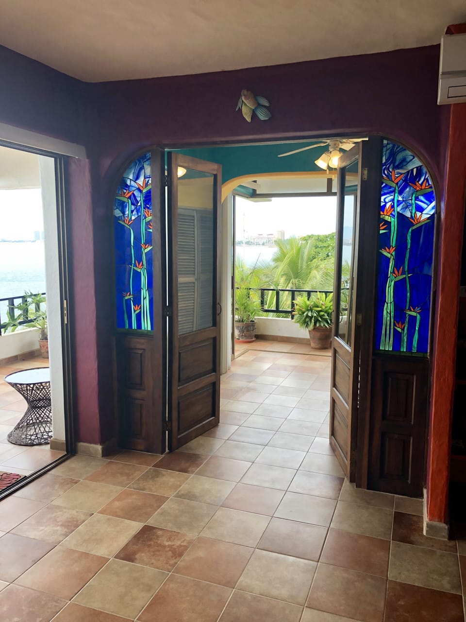 Looking out to the "guest" or "day" room and out to the water form living room