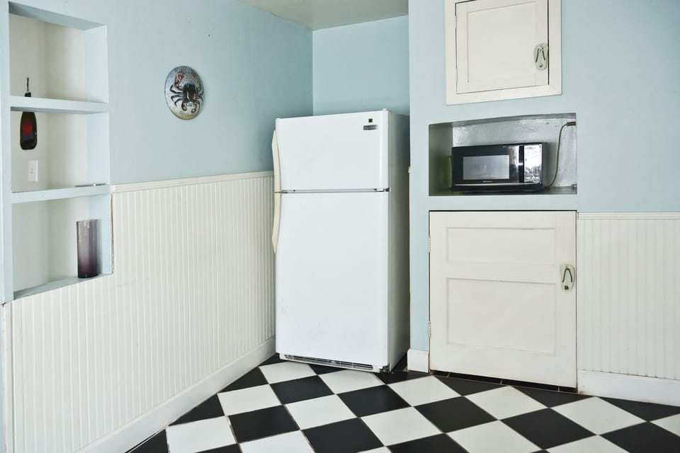 Kitchen has microwave and handy extra storage.