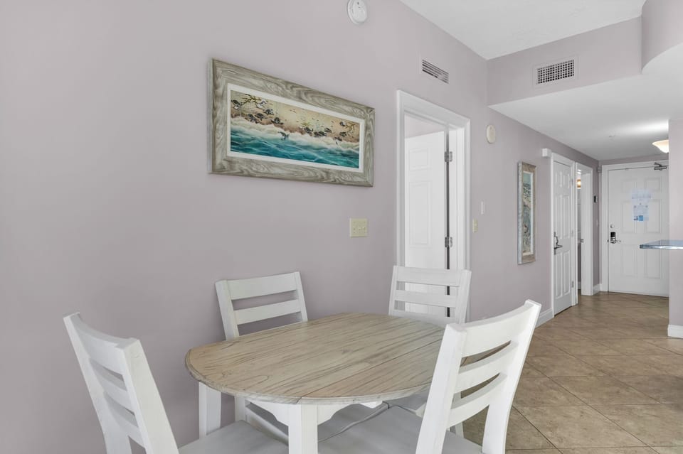 Dining Area - This inviting dining area seats four comfortably, offering a stylish setting to relish homemade dishes with a picturesque beach view.
