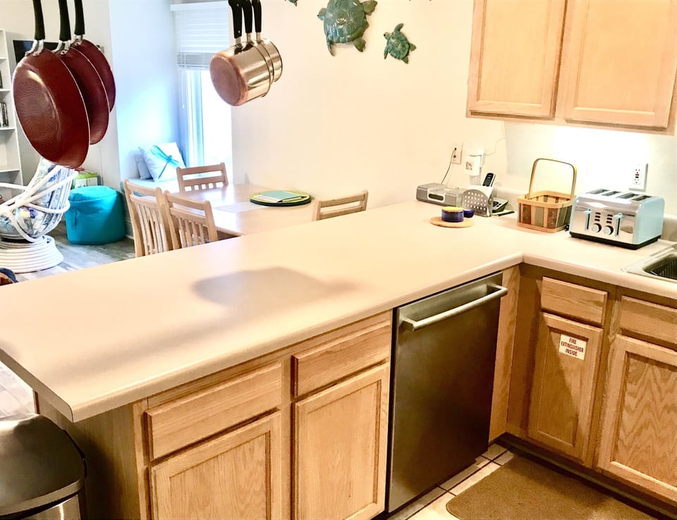 Kitchen view with stainless steel dishwasher.
